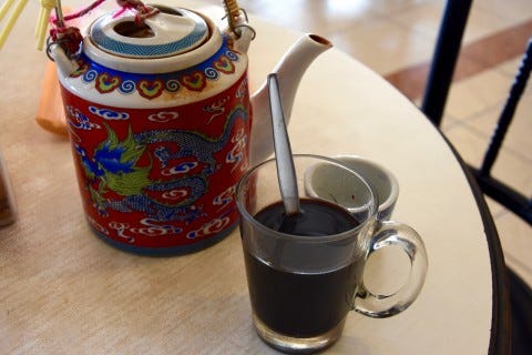 Jasmine tea alongside a cup of famed Trang coffee, or kopi. Photo: David Luekens