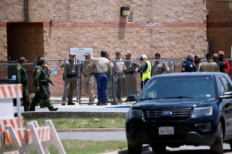 Law enforcement, and other first responders, gather outside Robb Elementary School following a shooting, Tuesday, May 24, 2022, in Uvalde, Texas.