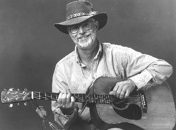 May be a black-and-white image of 1 person, playing a musical instrument and guitar