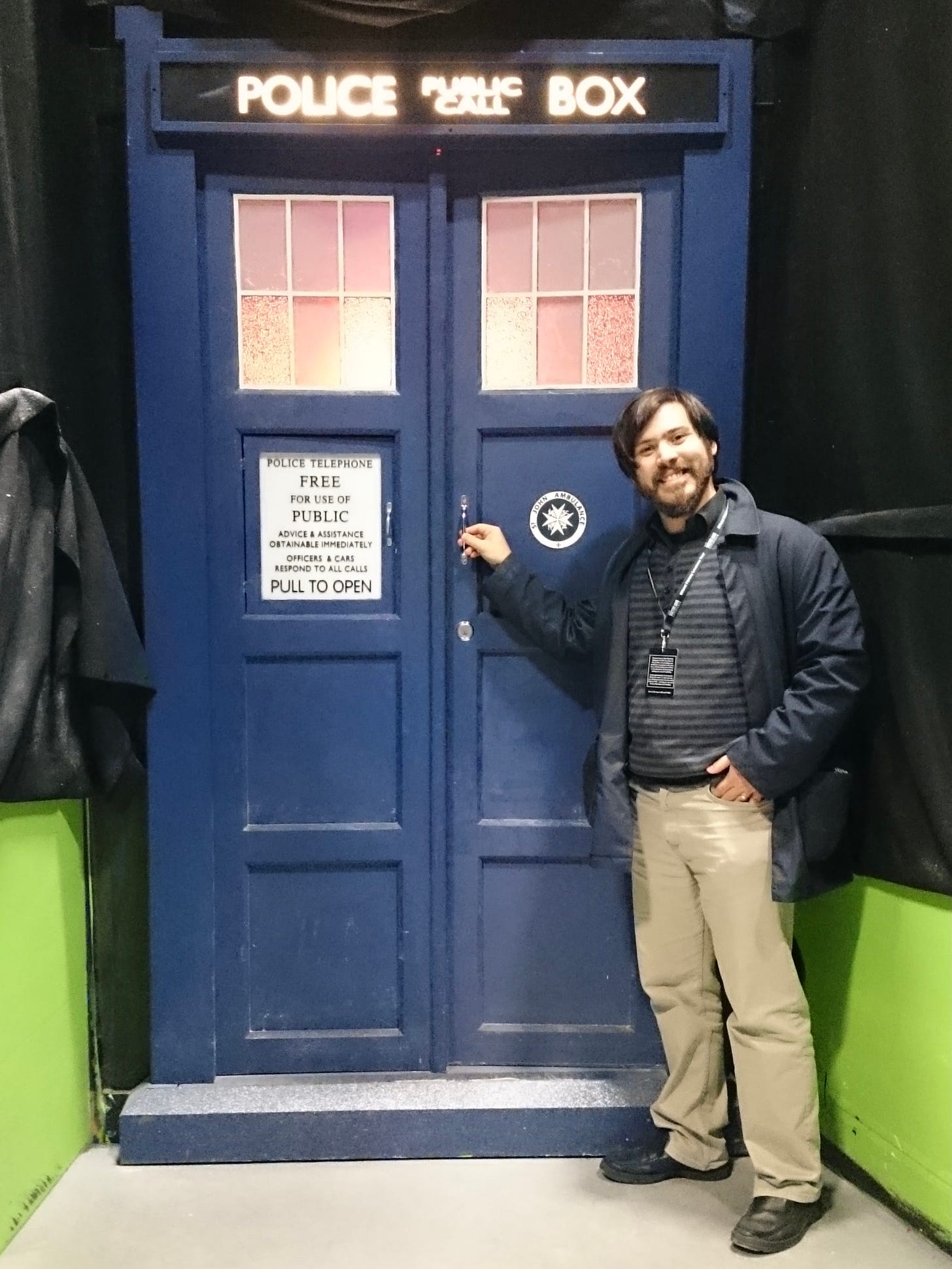 Photo of me standing in front of Doctor Who's TARDIS door on set at the BBC Roath Lock studios