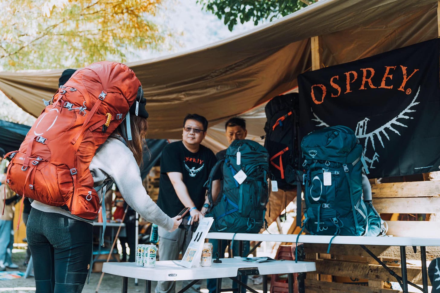 people at outdoor festival in Taiwan looking at backpacks people at outdoor festival in Taiwan looking at backpacks