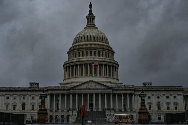 The Capitol building with storm clouds in the background.