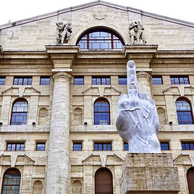 36ft middle finger is how Milan occupies their Wall Street. This sculpture  by Maurizio Cattelan has been said to be flipping off the Italian stock  exchange (building behind) since 2010. Had to