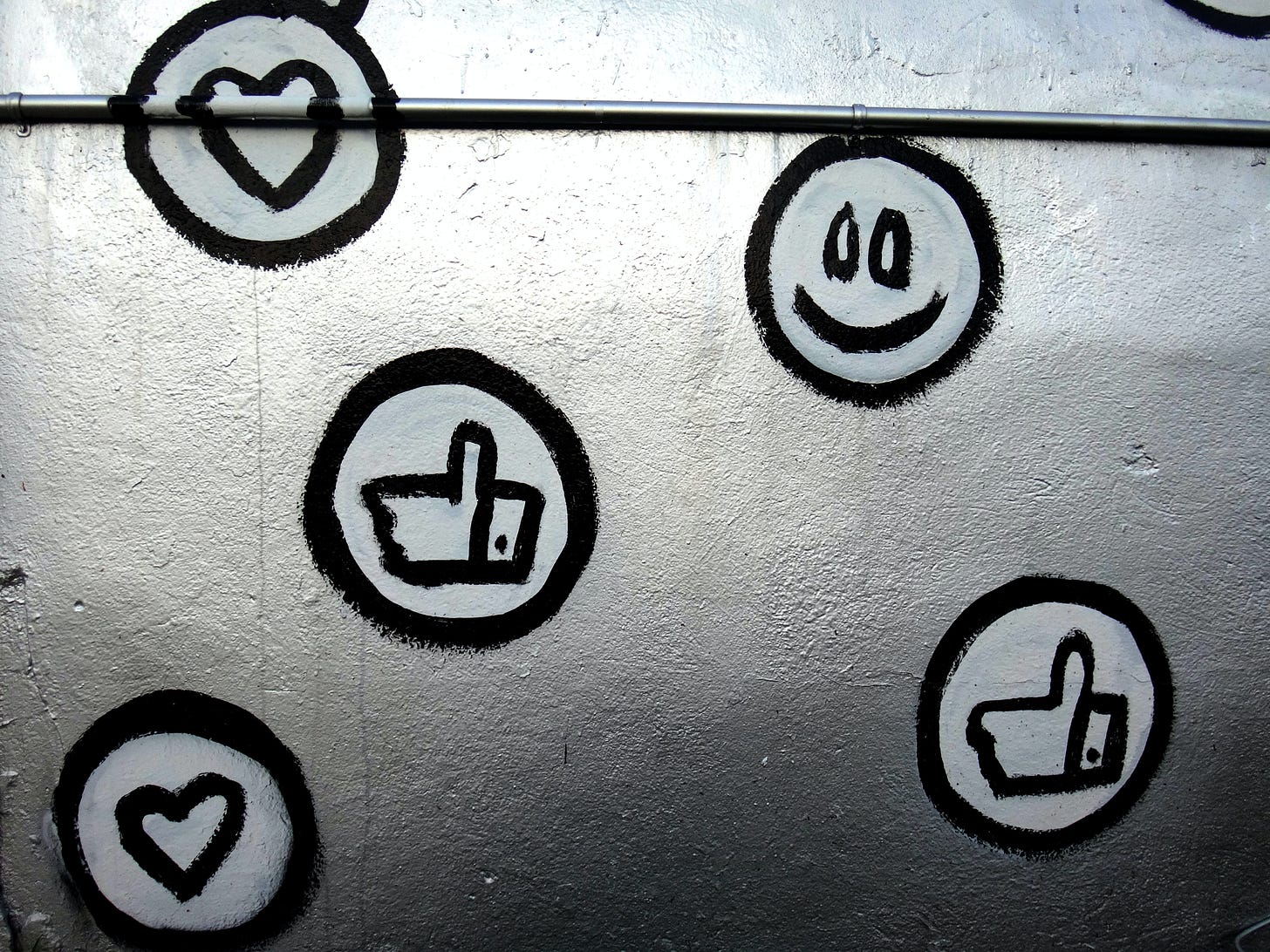 Photo of Facebook reaction emoji painted onto a wall. George Pagan III / Unsplash