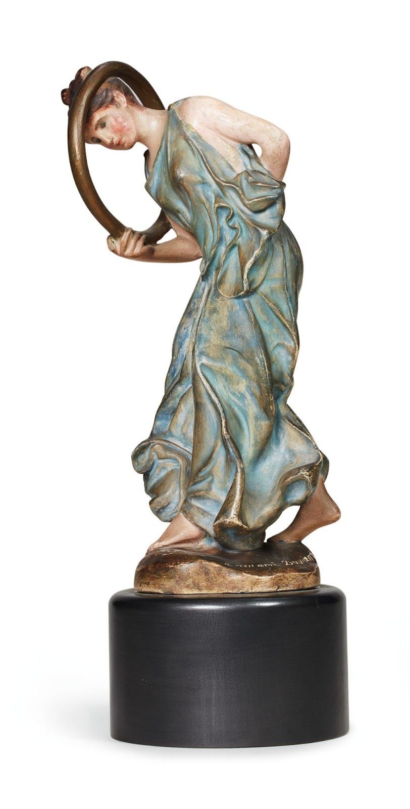 a statue of a girl in a robe holding a hoop around her neck
