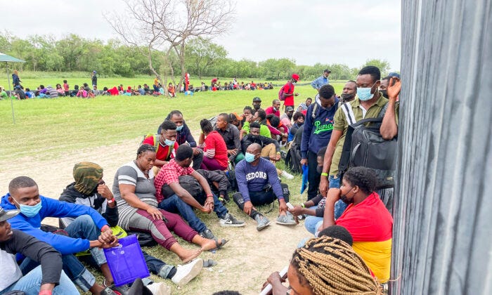 A group of more than 350 illegal immigrants wait for Border Patrol after crossing the Rio Grande from Mexico into Del Rio, Texas, on July 25, 2021. (Charlotte Cuthbertson/The Epoch Times)