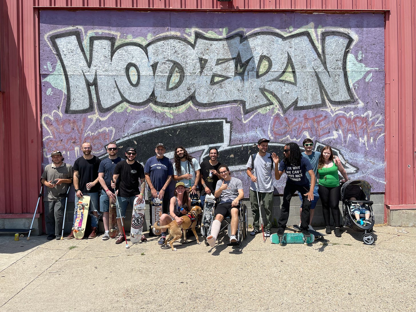 The largest gathering of of Blind and Adaptive Skaters in the History of the World! pictures in front of rad graffiti saying Modern skate