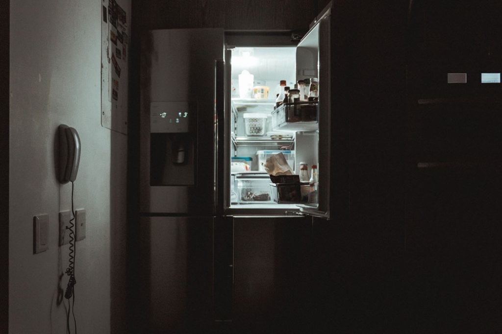 open fridge in dark room