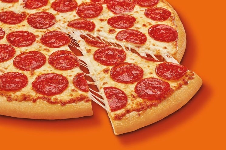 Closeup of a pizza with pepperoni slices