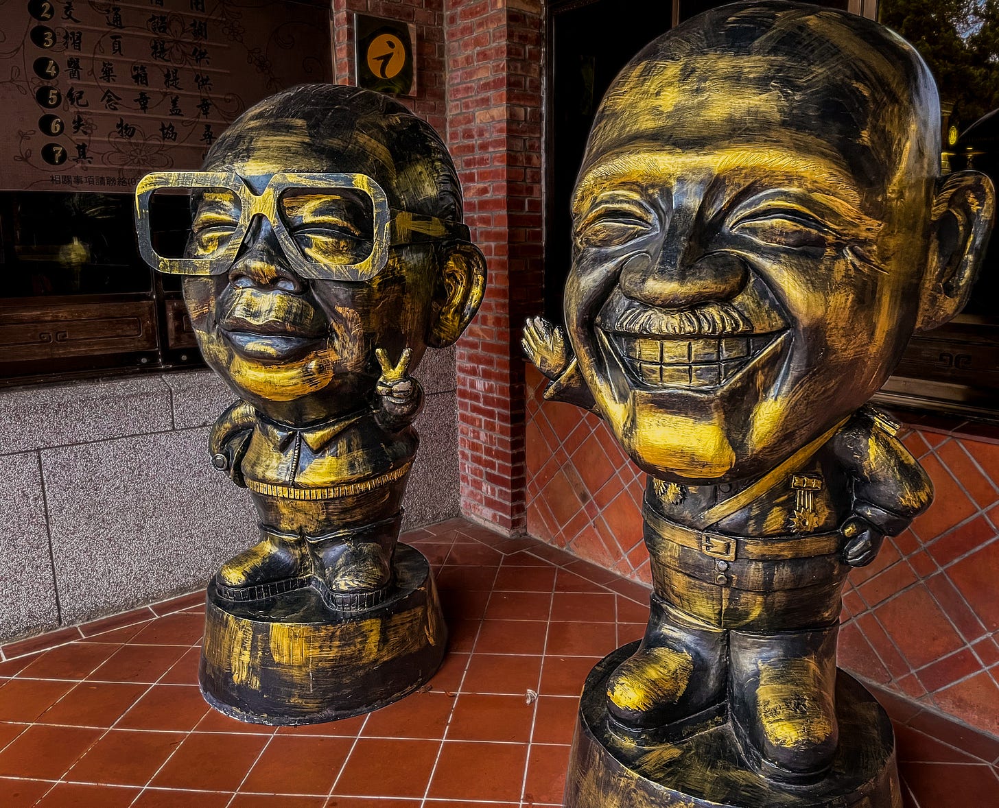 Cartoonish brass statues of Chiang Kai-shek and Chiang Ching-kuo sit outside the visitor center at Taoyuan’s Cihu Park Cartoonish brass statues of Chiang Kai-shek and Chiang Ching-kuo sit outside the visitor center at Taoyuan’s Cihu Park