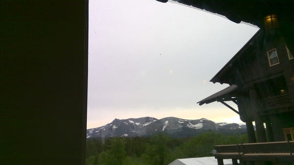 My view out the sun porch window of the back of the lodge and the mountains. Sorry for the poor photo quality. I had to t