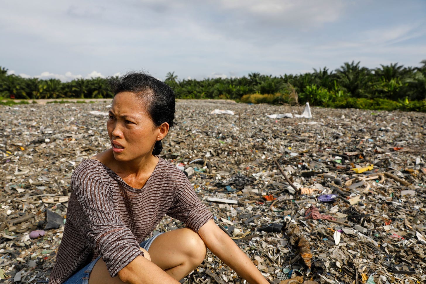 Pua Lay Peng, a resident-turned-activist, checks out an illegal dumping site near Jenjarom, Feb. 2. From 1950 to 2015, a stag