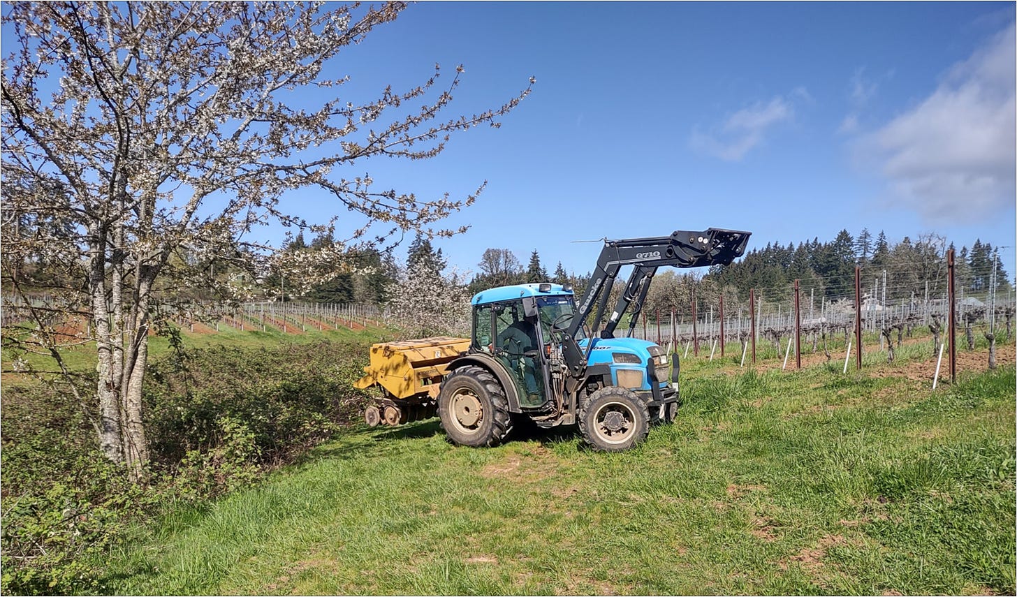 Beautiful day for Ernie to drill in cover crop with bud break starting and cherry trees blooming.