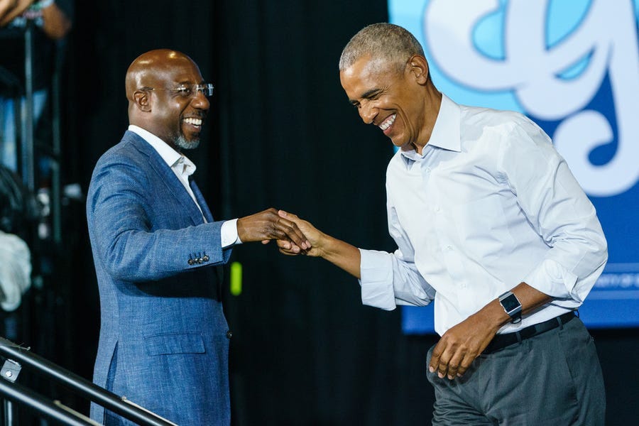 Former President Barack Obama greets Sen. Raphael Warnock, D-Ga., as he arrives at a campaign event for Georgia Democrats on October 28, 2022 in College Park, Georgia.