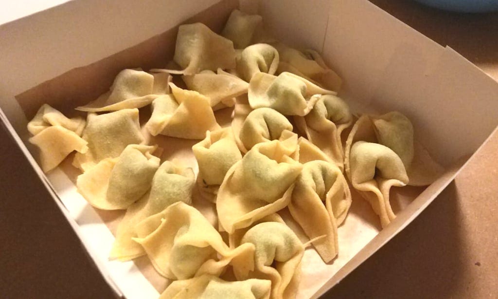 A box of hand-made tortellini pasta, filled with spinach and ricotta