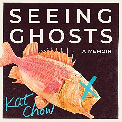 Cover of the audiobook of Seeing Ghost. The title appears in white capital letters on a black background. Below it there’s a large fish with red scales and a blue x mark over its eye.