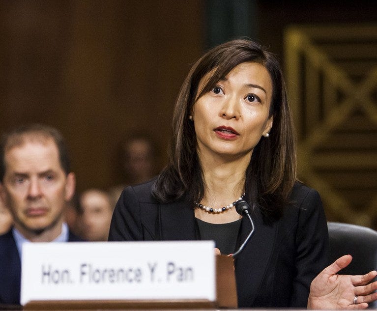 Judge Florence Pan testified at a Senate hearing. She is seated behind a microphone and a name plate.