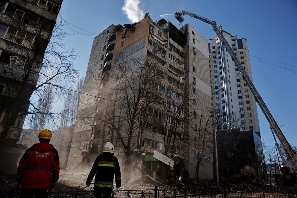 Rescuers work next to an apartment building that was hit by shelling in Kyiv, Ukraine on March 16, 2022.