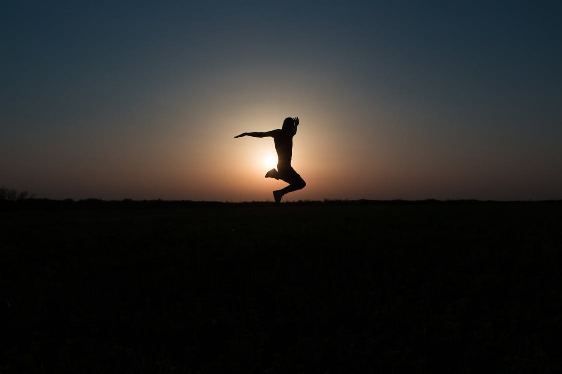 Free Silhouette Photo of Jumping Person during Twilight Hour Stock Photo
