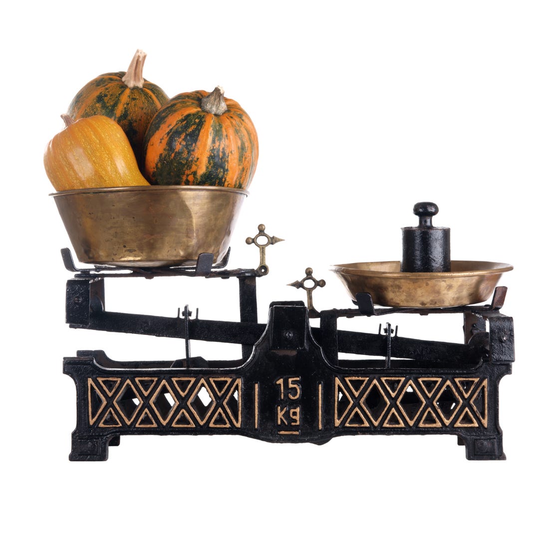 Image of old fashioned balance scale weighing squash against a known weight.