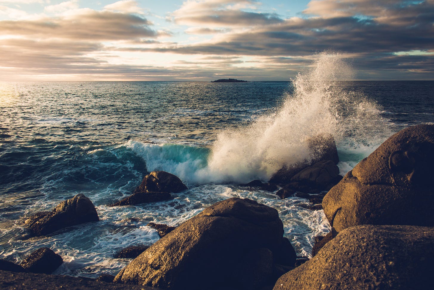 Photo of an ocean wave against rocks