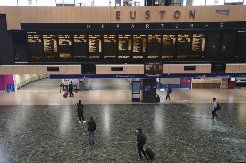 Passengers stand around inside Euston station in London on the first day of a rail strike on Tuesday June 21, 2022. Britain's biggest rail strikes in decades went ahead Tuesday after last-minute talks between a union and train companies failed to reach a settlement over pay and job security. Up to 40,000 cleaners, signalers, maintenance workers and station staff are due to walk out for three days this week, on Tuesday, Thursday and Saturday. (Stefan Rousseau/PA via AP)