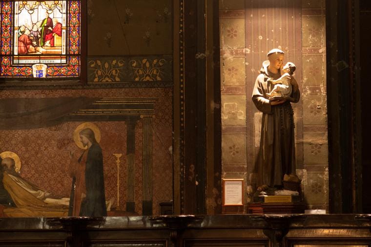 Candles illuminate the Blessed Mother and St. Anthony of Padua inside Saint-Sernin Church in Toulouse, France.