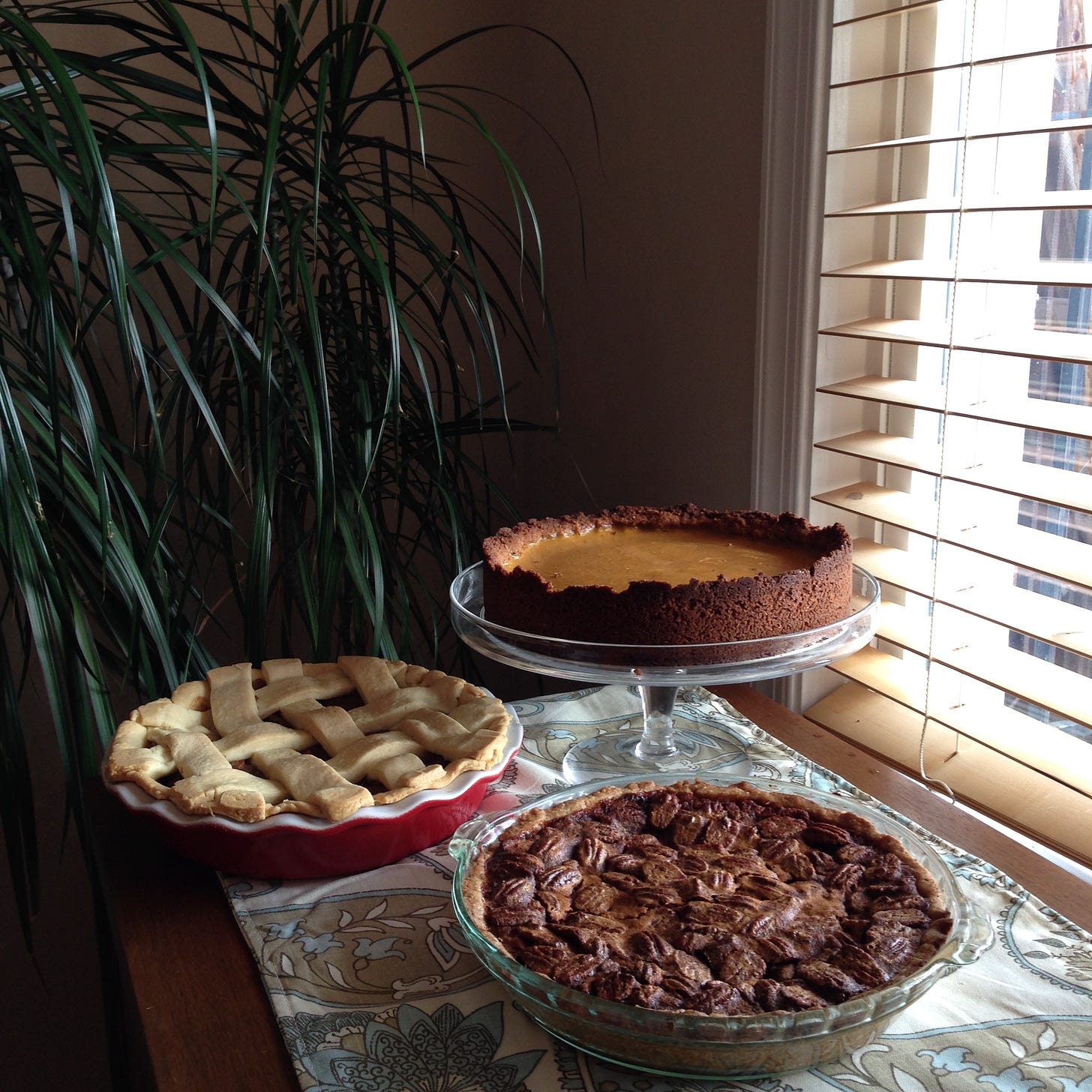 An assortment of pies on a dining room buffet. 