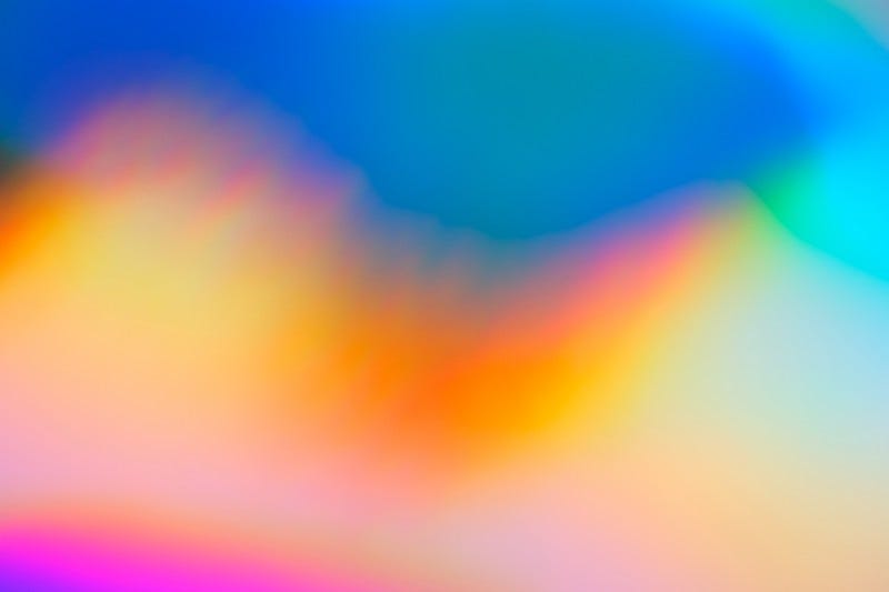 An image of a blurry rainbow plasma wave.