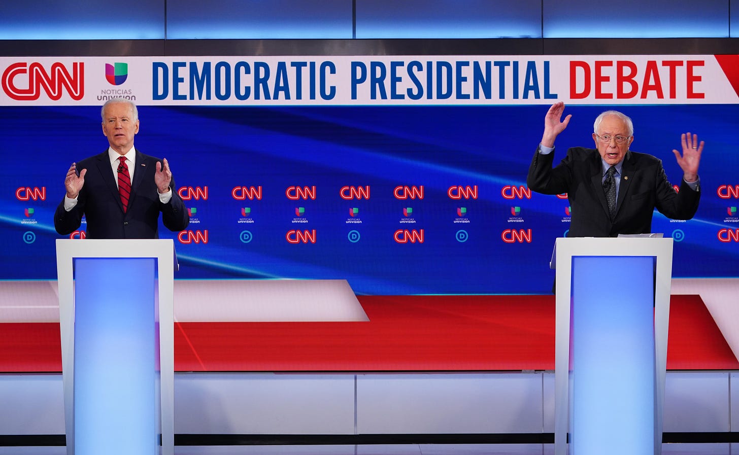 Biden stands next to Sanders at Democratic Presidential Debate