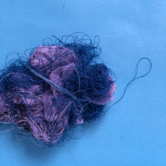 Year 5, Number Three, 34. Blue Purple. An animated loop of a tangled knot of purple and blue fabric scraps and thread unraveling and wadding up again.
