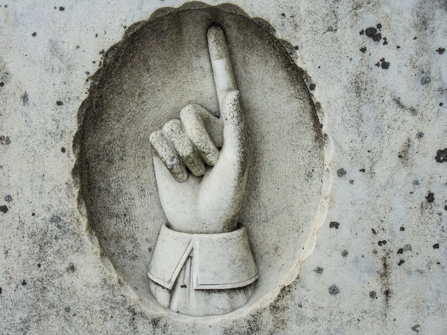 Finger on gravestone