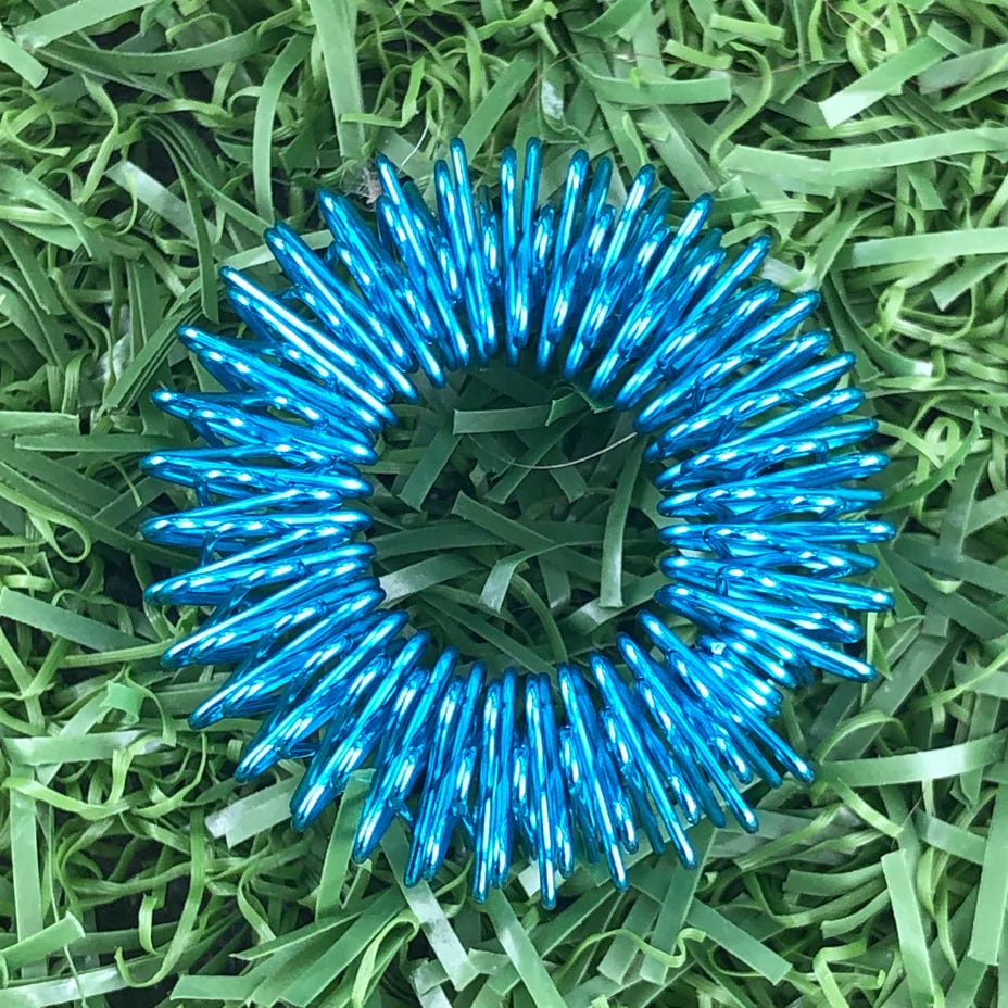 A bright blue coil fidget toy