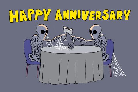 two skeletons having dinner with the words Happy Anniversary.