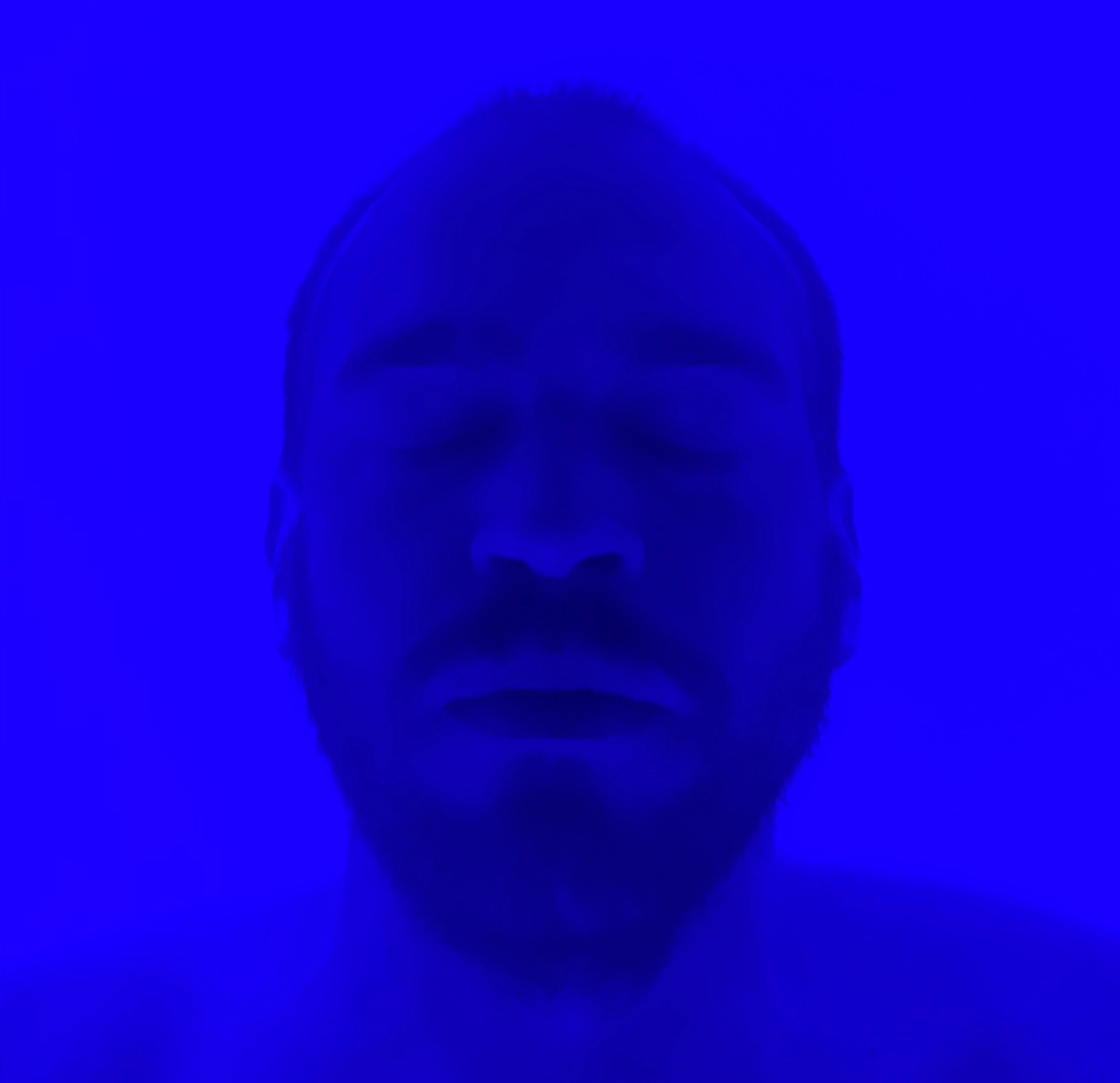 eyes closed in a float tank with blue light