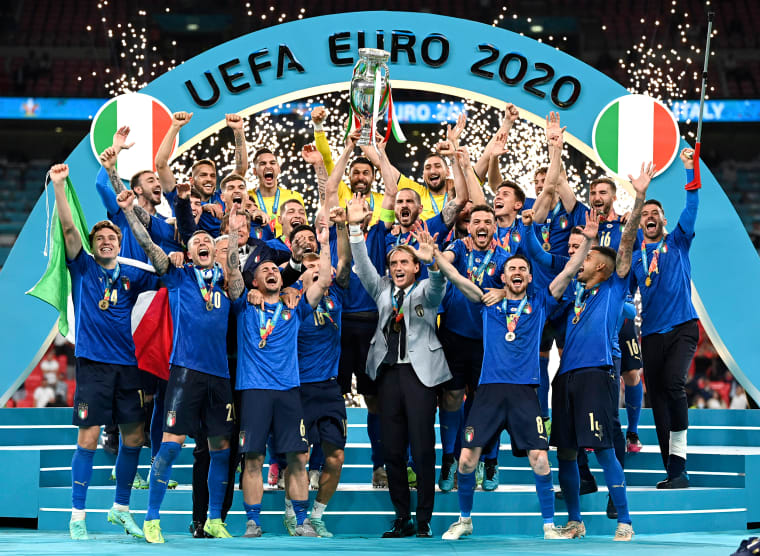 Image: Italy's team celebrates with the trophy on the podium after winning the Euro 2020 soccer championship final between England and Italy at Wembley stadium in London on July 11, 2021.