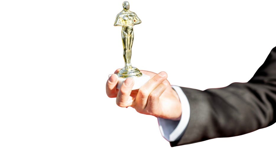 Arm holding small award statue