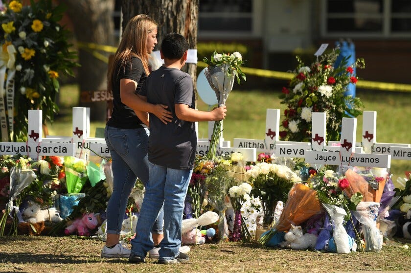 Crosses with the names of Tuesday’s shooting victims are placed outside Robb Elementary School in Uvalde, Texas, on Thursday.