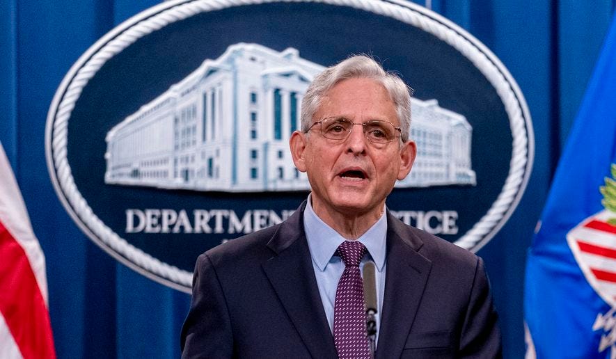 Attorney General Merrick Garland speaks at a news conference at the Justice Department in Washington, Monday, Nov. 8, 2021. Two suspected criminal hackers have been charged in the United States in connection with a wave of ransomware attacks. That includes one that led to the temporary shutdown of the world’s largest meat processor and another that snarled businesses around the globe on the Fourth of July weekend. Garland and other top officials announced charges Monday against Ukrainian Yaroslav Vasinskyi and Russian Yevgeniy Polyanin, alleging them to be part of the REvil ransomware gang.(AP Photo/Andrew Harnik)
