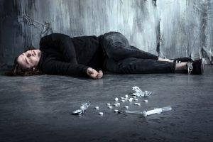 © Dmytro Sidelnikov/ 123RF.com addict lying alone in dark after taking heroin and pills