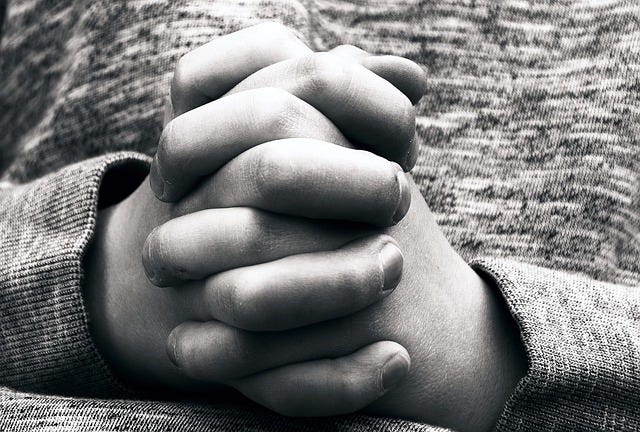 Closeup of child's praying hands
