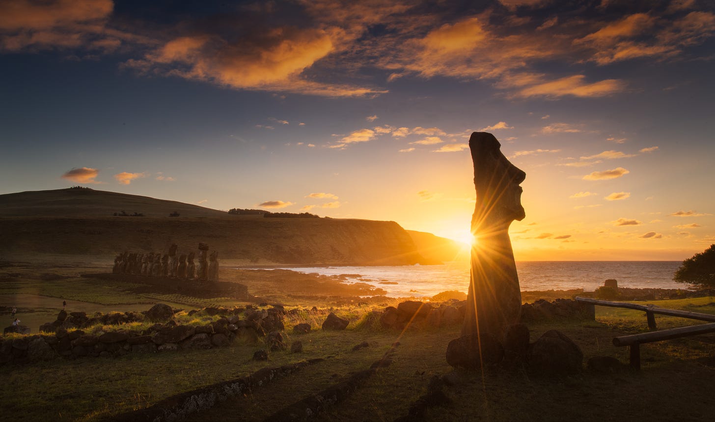 Sunset glinting off a lone Rapa Nui Moai