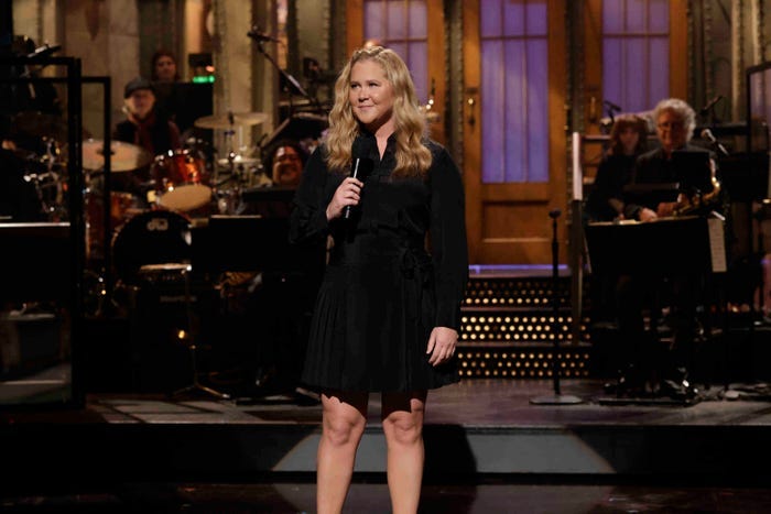 Amy Schumer hosting "Saturday Night Live" wearing a black dress