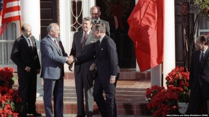 Soviet leader Mikhail Gorbachev (second from left) shakes hands with U.S. Vice President George Bush as President Ronald Reagan stands behind them before talks in New York in December 1988.