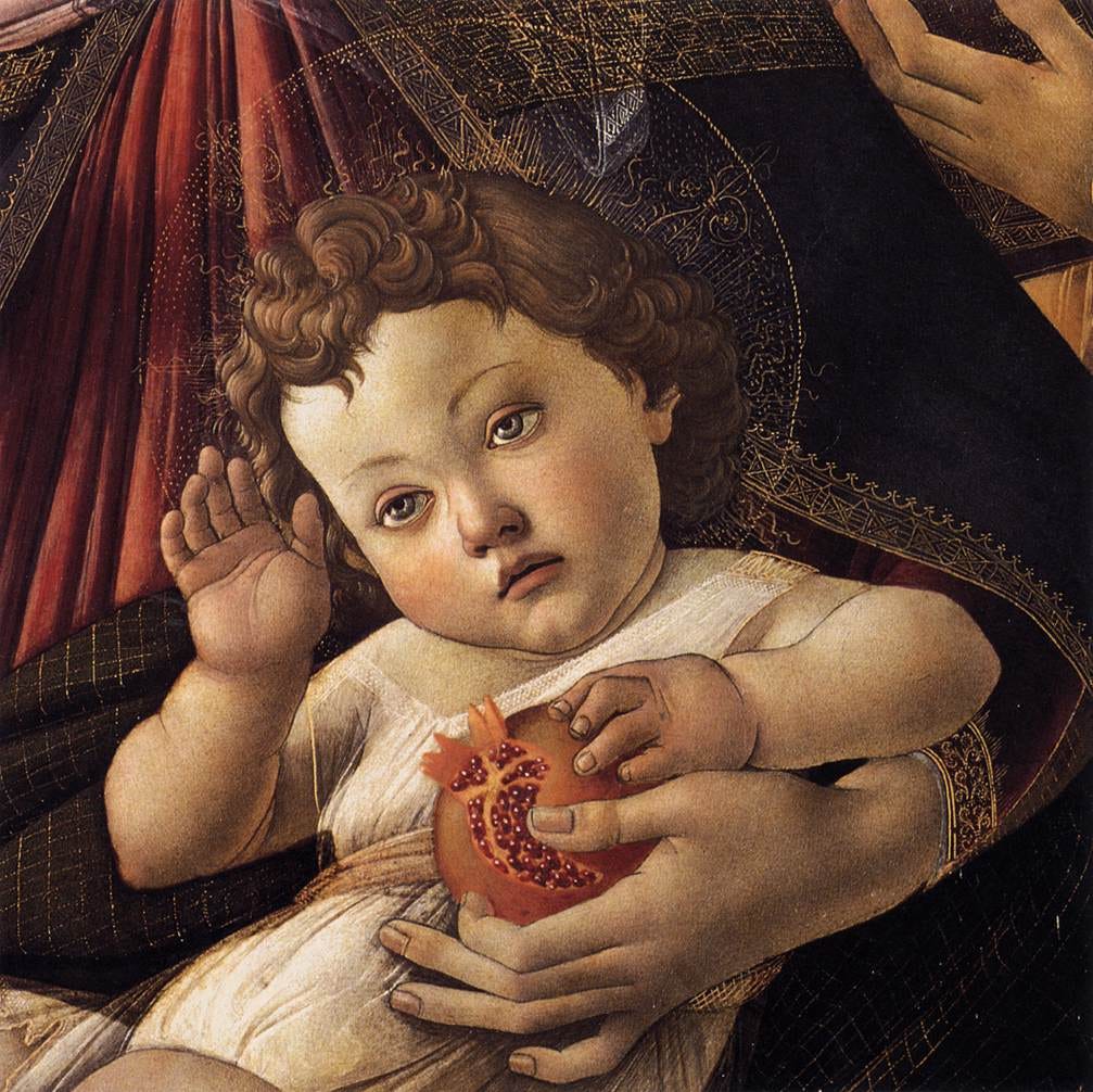 Italian Renaissance portrait of the infant Jesus with auburn curly hair, one hand raised, the other grasping a sliced-open pomegranate as the Holy Mother's left arm cradles him. Her face is unseen, as this is just a detail of the portrait by Boticelli.