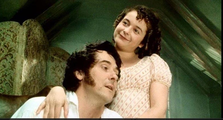 Lydia Bennet stands above a seated Mr. Wickham, embracing him: Lydia Bennet in pre-wedded bliss: One of the most interesting and challenging things Austen does is to often give her worst characters, such as Mr. Wickham, a decent ending, if not a happy one, not a punishing one either. Seen here: Adrian Lukis and Julia Sawalha in the 1995 series ‘Pride and Prejudice” Lydia Bennet stands above a seated Mr. Wickham, embracing him: Lydia Bennet in pre-wedded bliss: One of the most interesting and challenging things Austen does is to often give her worst characters, such as Mr. Wickham, a decent ending, if not a happy one, not a punishing one either. Seen here: Adrian Lukis and Julia Sawalha in the 1995 series ‘Pride and Prejudice”