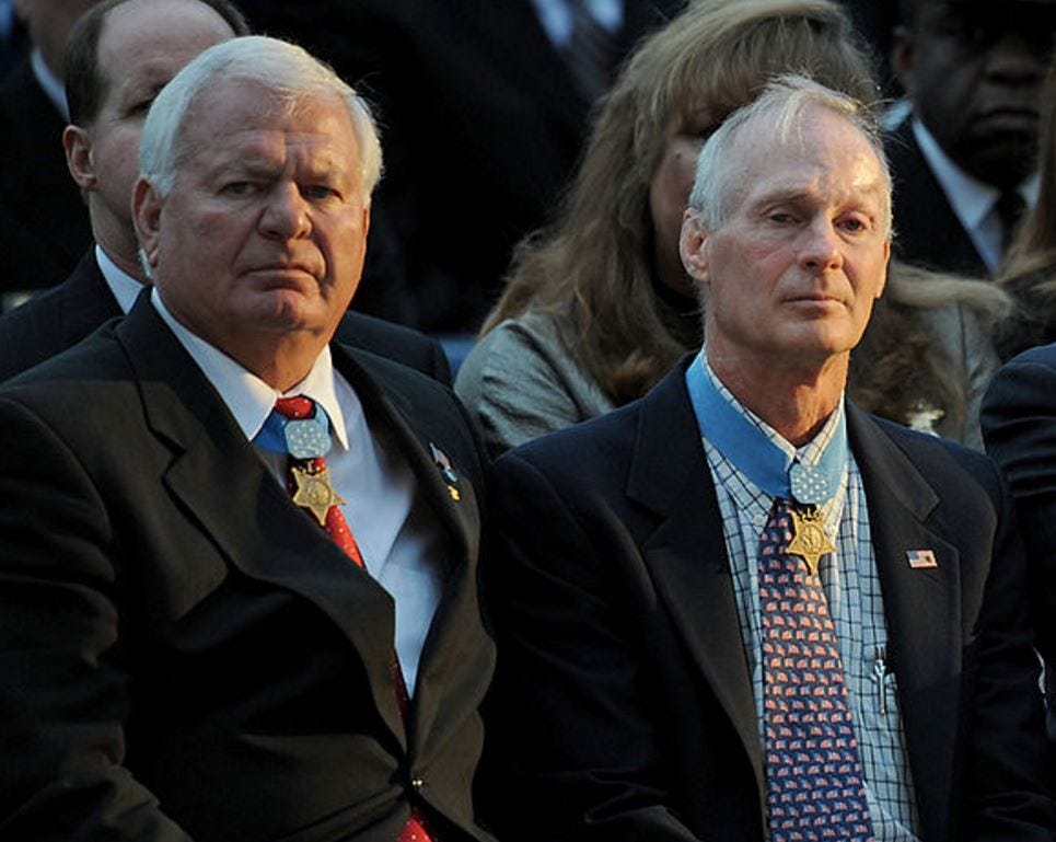 Michael Thornton and Tom Norris are pictured at the Medal of Honor flag presentation ceremony for Master-at-Arms 2nd Class (Seal) Michael A. Monsoor.