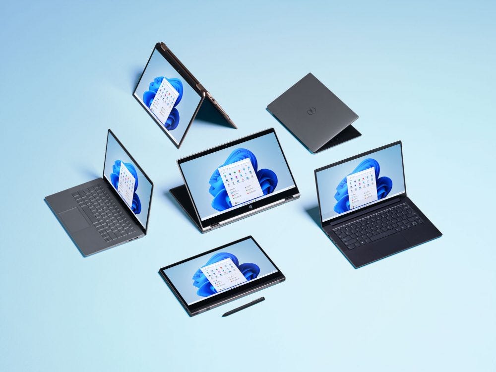 Windows 11 shown on a group of laptops. (Microsoft)