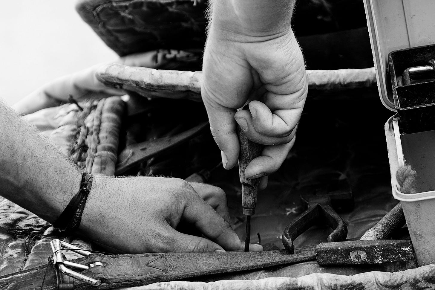 hands working on a leather belt for article titled legitimacy of a business of one by Larry G. Maguire