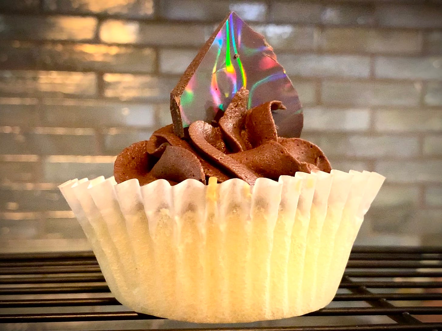 Cupcake with chocolate buttercream and a rainbow chocolate shard topper